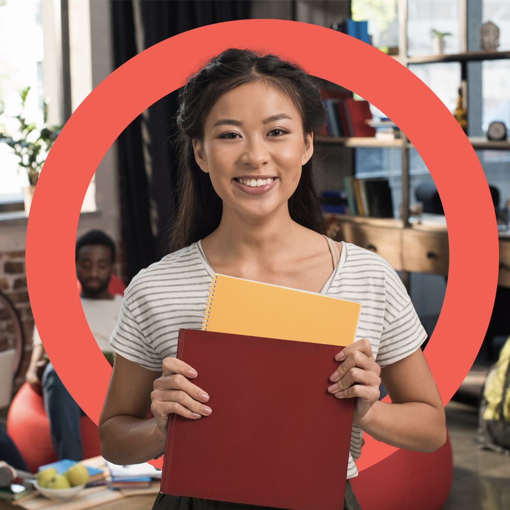 Smiling female IB student holding notebooks, representing Pamoja's dedication to supporting every IB student in their academic journey.