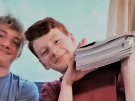 Wolsey Hall Oxford students, Sebastian, Aiden, and Ella with their textbooks.