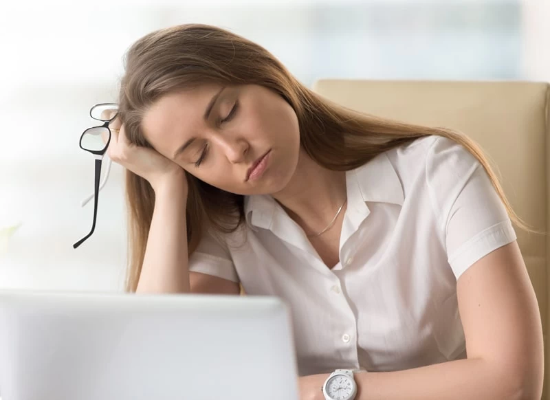 Older teenage girl asleep at her desk.