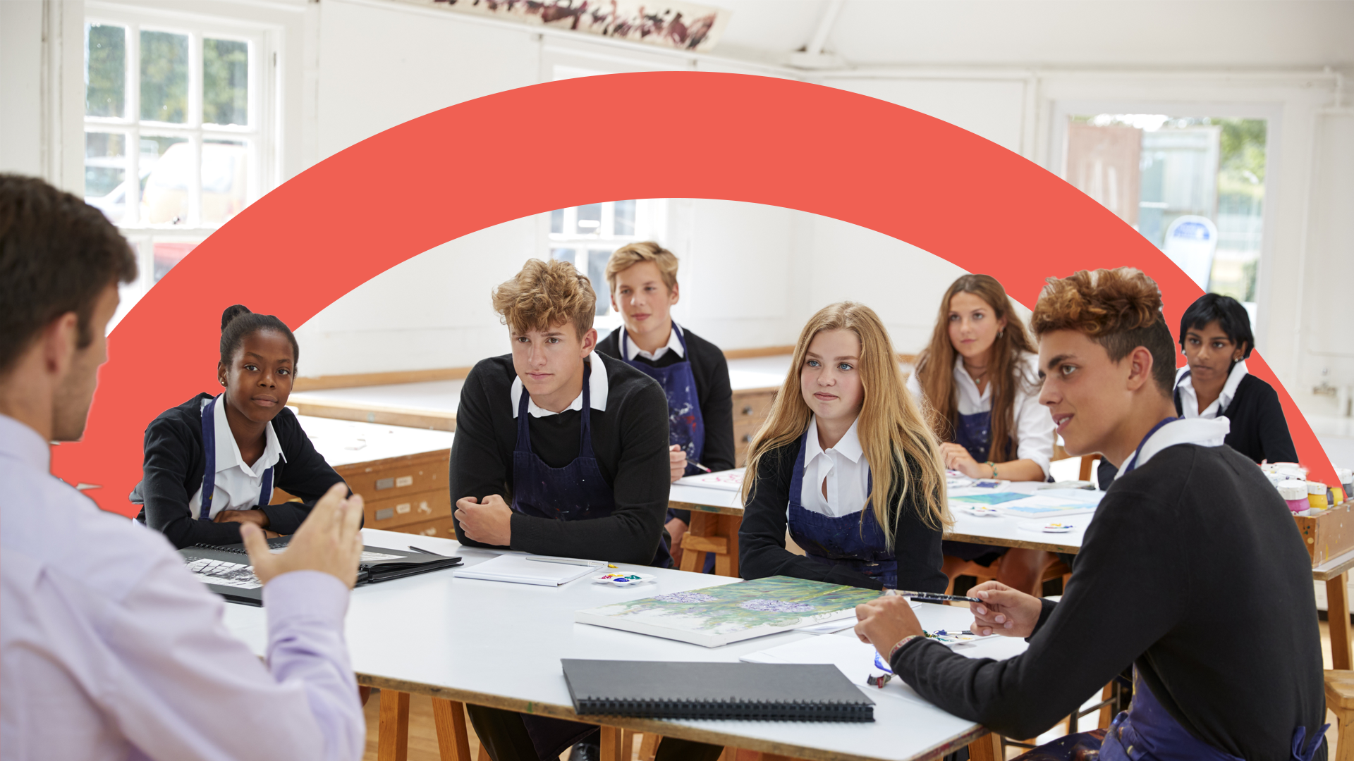 Diverse group of high school students in a classroom listening to their teacher, representing the wide range of learners Pamoja supports.