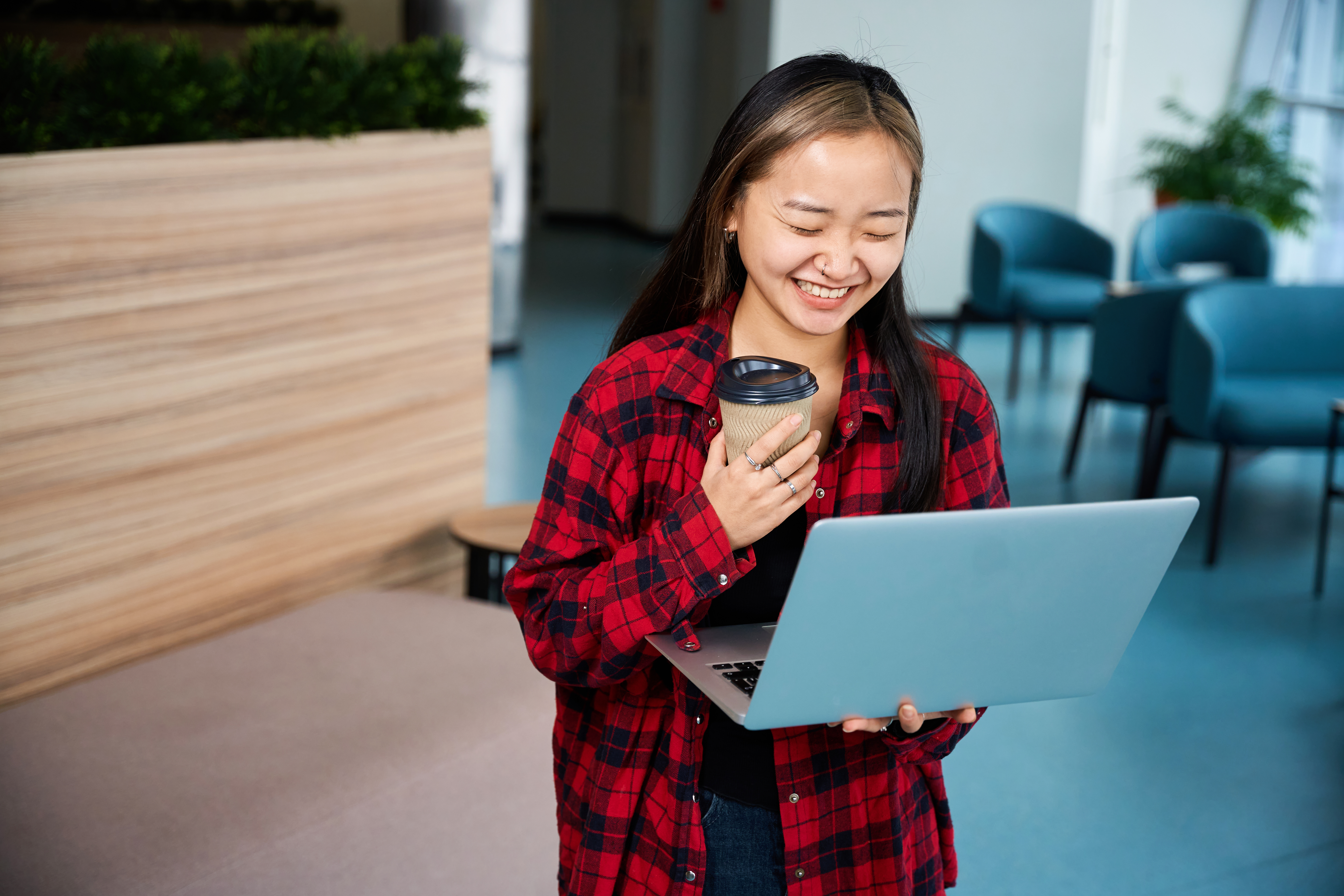A blurry, long-exposure photo of people moving quickly on and around escalators in a bright, modern corporate or public building, symbolizing the fast pace of business management.