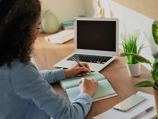 Older female student creating a list.