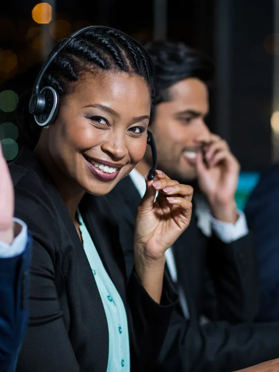 Pamoja Education support team smiling agent ready to take a call.