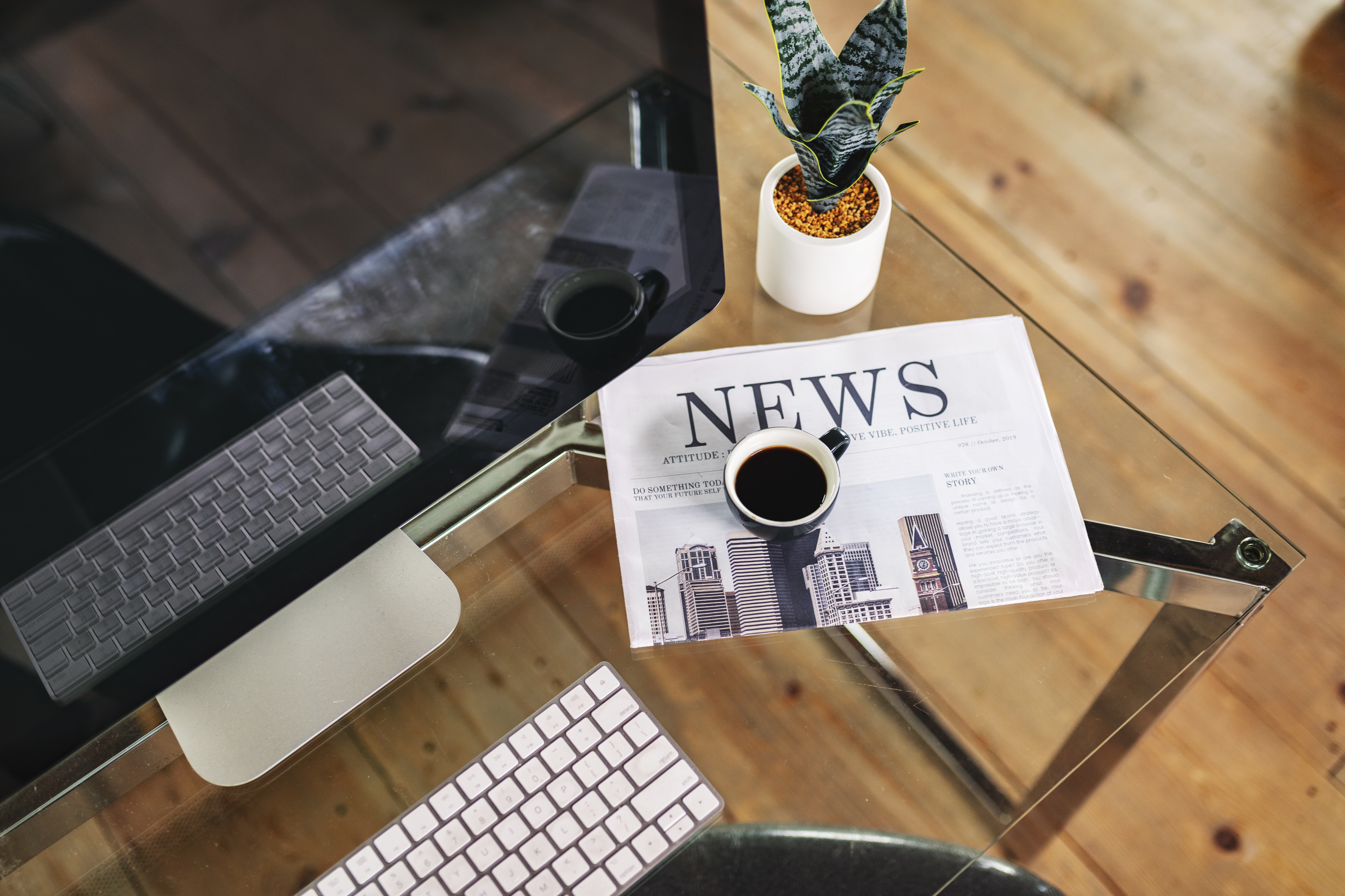 A flat lay image of a newspaper open to the headline 