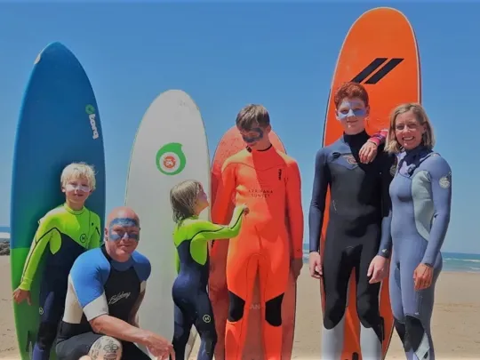 Family photo of the Binedells getting ready to surf.