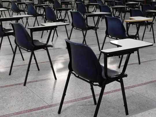 Chairs and desks in an exam hall.