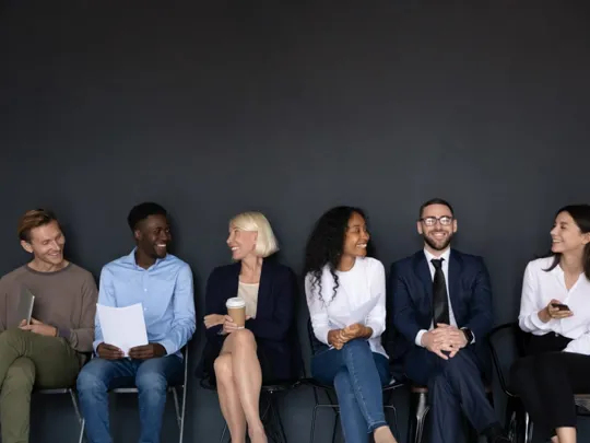 Row of adults all sat in a line.