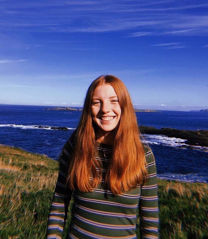 Wolsey Hall Oxford student, Lucy, stood on a cliff over looking the sea.