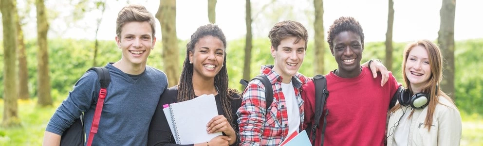 A group of teenagers smiling at the camera. 