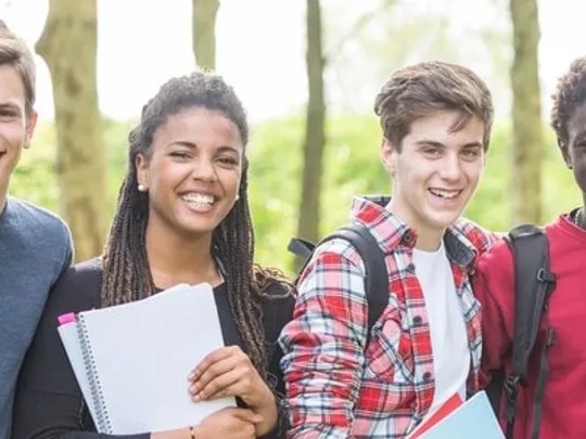 A group of teenagers smiling at the camera.