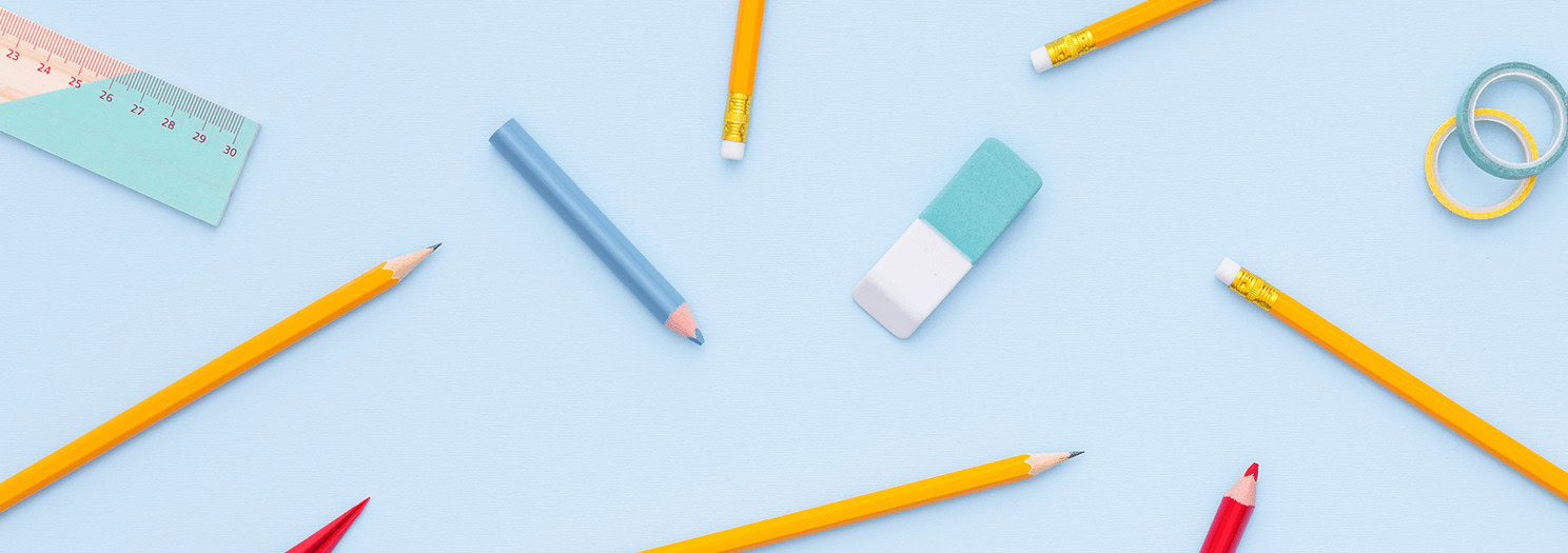A flat-lay image of various school supplies scattered on a light blue background. The supplies include yellow and colored pencils, a blue eraser, a ruler, and washi tape.