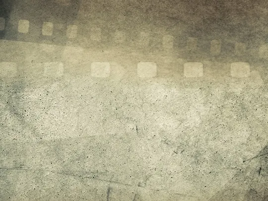 A vintage-style background with a weathered, grainy texture. The faint, transparent outline of a filmstrip with perforations is visible across the top and down the sides of the image. The image evokes themes of filmmaking, photography, and history.