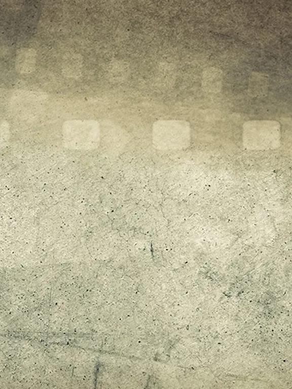 A vintage-style background with a weathered, grainy texture. The faint, transparent outline of a filmstrip with perforations is visible across the top and down the sides of the image. The image evokes themes of filmmaking, photography, and history.