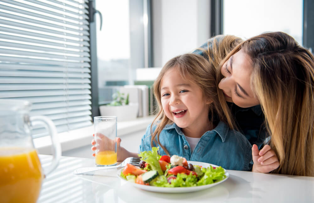 Child eating a healthy salad.