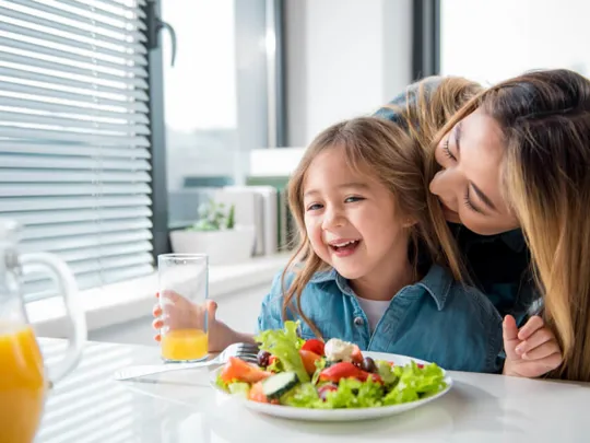 Child eating a healthy salad.
