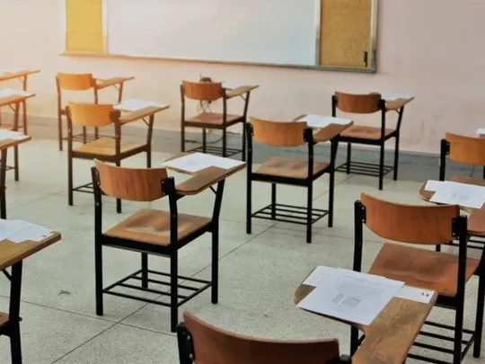 Desks and chairs in an exam centre.