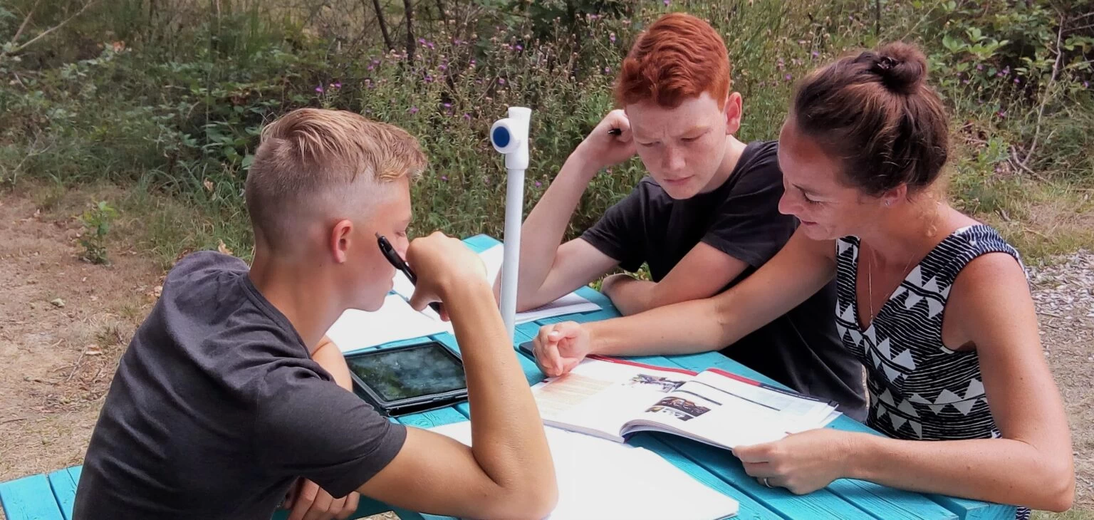 Karren helping Aiden, and Sebastian. 