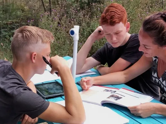 Karren helping Aiden, and Sebastian.