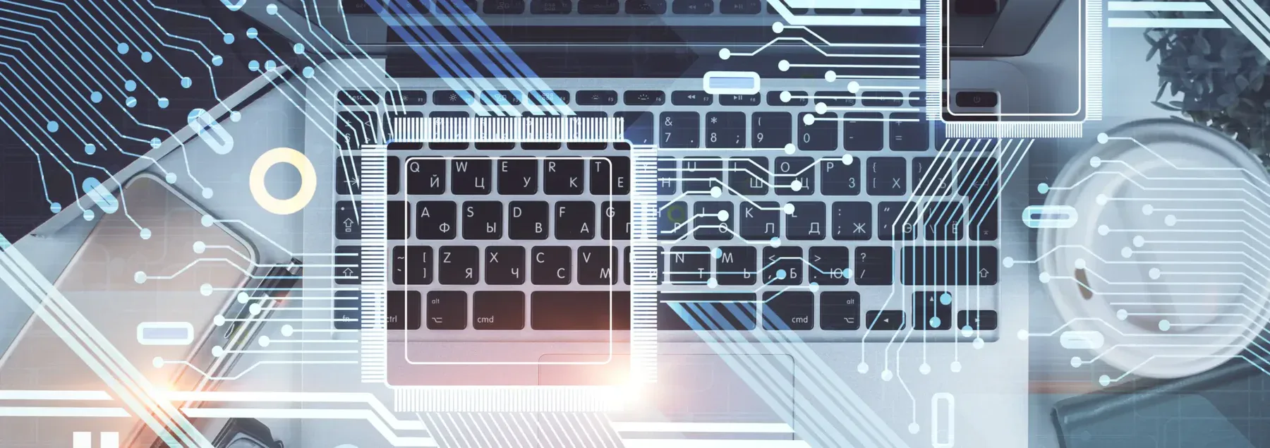 An overhead view of a laptop keyboard and mouse, with digital circuit lines and geometric shapes superimposed on the image. The image is an abstract representation of computer science and technology.