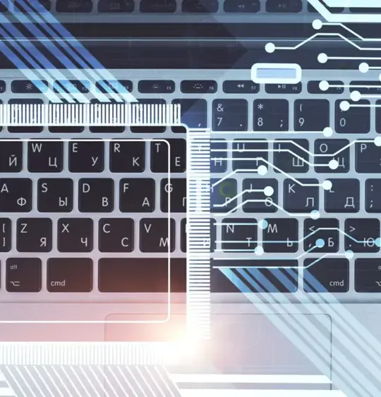 An overhead view of a laptop keyboard and mouse, with digital circuit lines and geometric shapes superimposed on the image. The image is an abstract representation of computer science and technology.